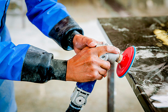 Closeup of pneumatic water polisher for granite countertops.