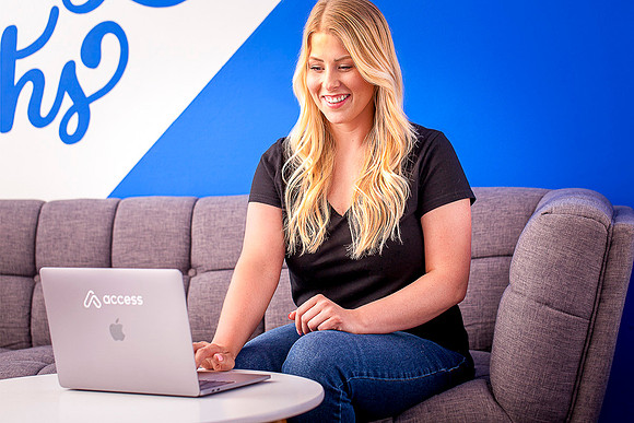 Young woman checks email on her laptop.