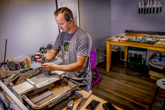 Artisan knife sharpener at work in his shop.