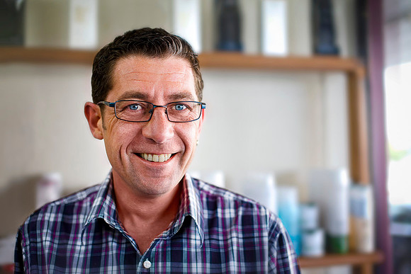 Portrait of male hairdresser in Australia.