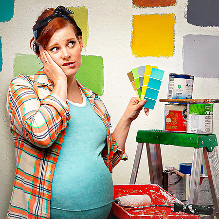 Pregnant woman painting cannot decide on color for nursery.