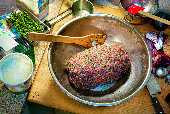 Greek-inspired meat loaf preparation in mixing bowl.