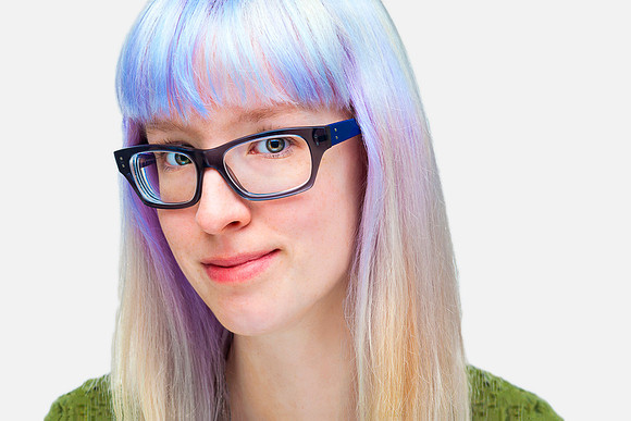 Young woman with blue hair and glasses.