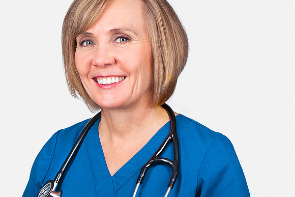 Headshot of a woman nurse in her forties in blue scrubs with stethoscope at Alta View Hospital.