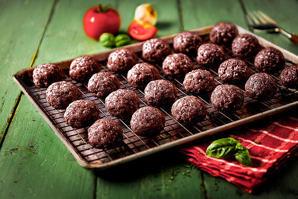 24 baked meatballs on sheet pan, fresh from the oven.